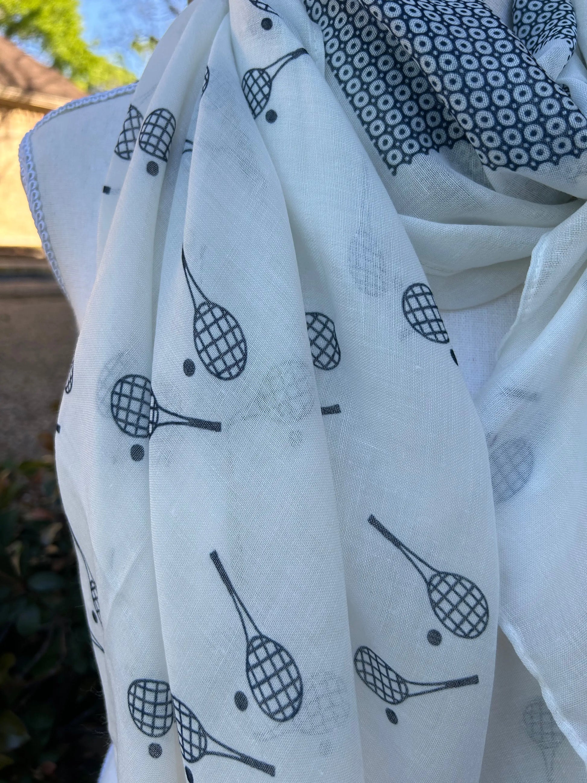 Protect yourself from the sun in style with our versatile Racquet Sun Scarf/Wrap. Stay cool and fashionable on and off the court. 