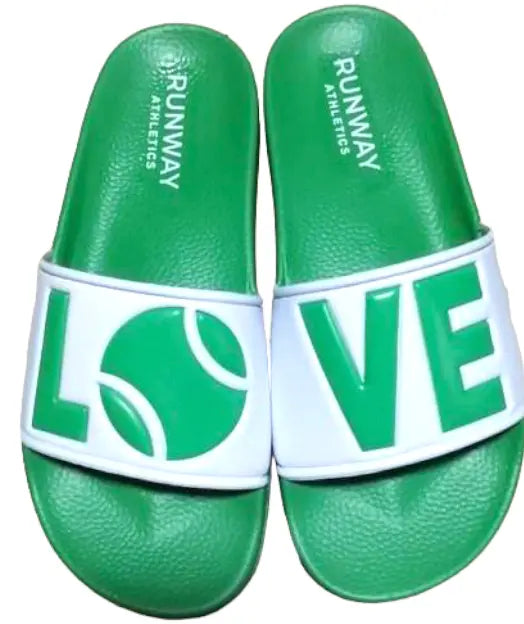 Shop these green & white slides on feet- Runway Athletics. You do not want to miss out on our custom-made LOVE slides!